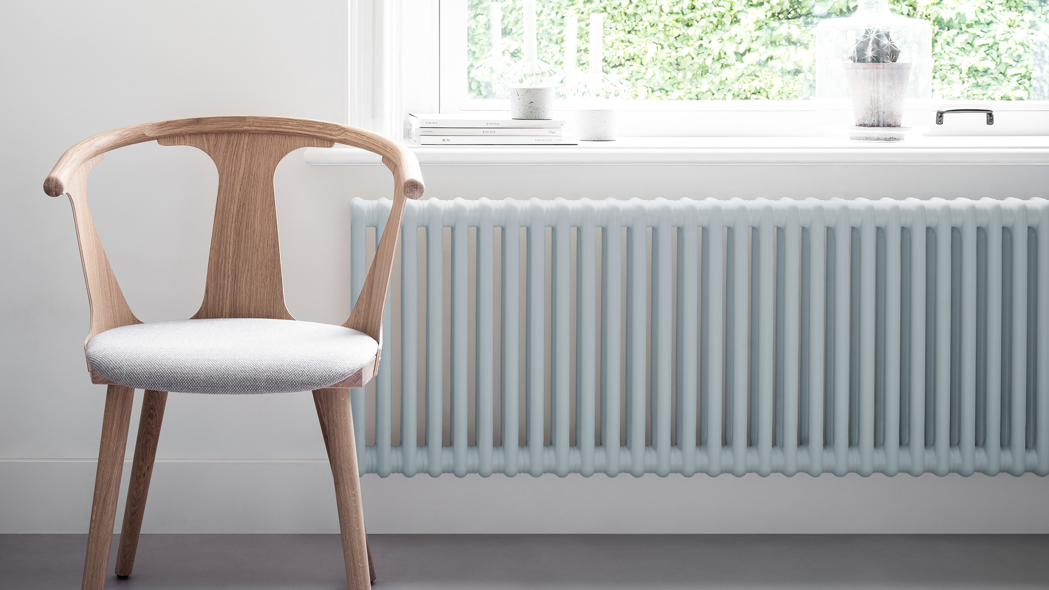 A light blue radiator underneath a window dulux-simply-refresh-radiators-ideas-global-4