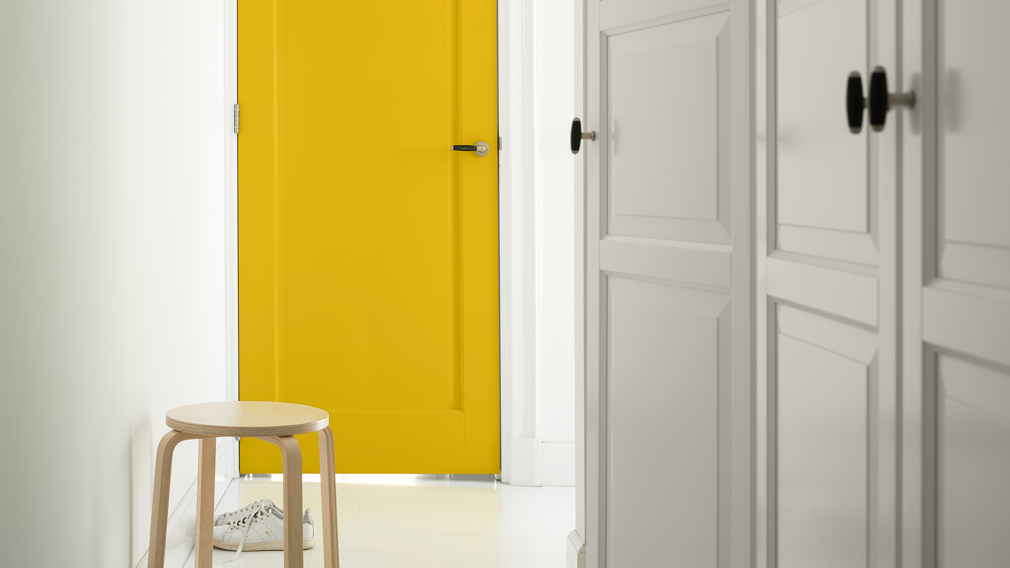 Bright yellow door in white hallway dulux-simply-refresh-windows-doors-ideas-global-5