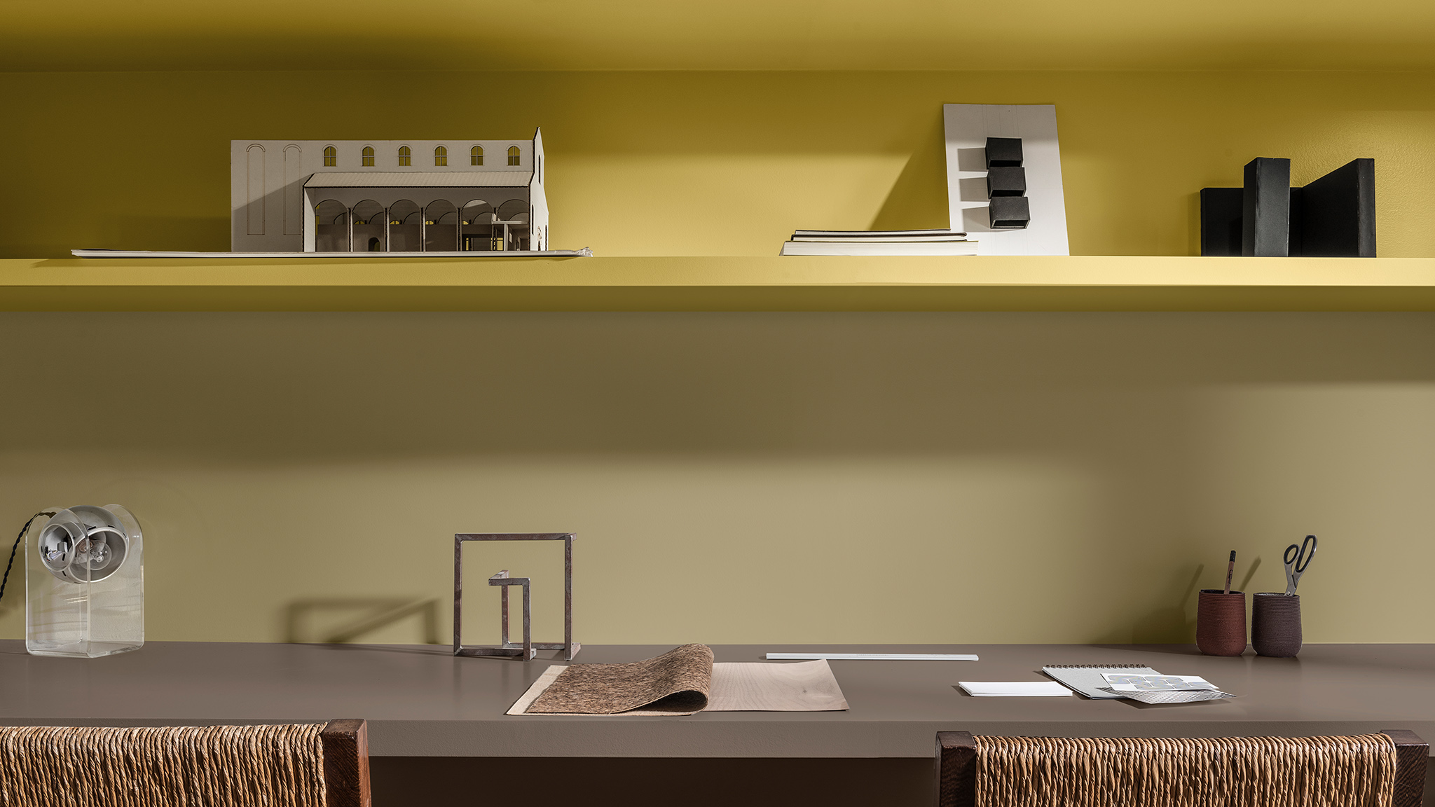 Study shelves painted in yellows and Brave Ground, plus two woven-backed chairs. Dulux_CF21_ Colour_of_the_year_Timeless_colors_global_4